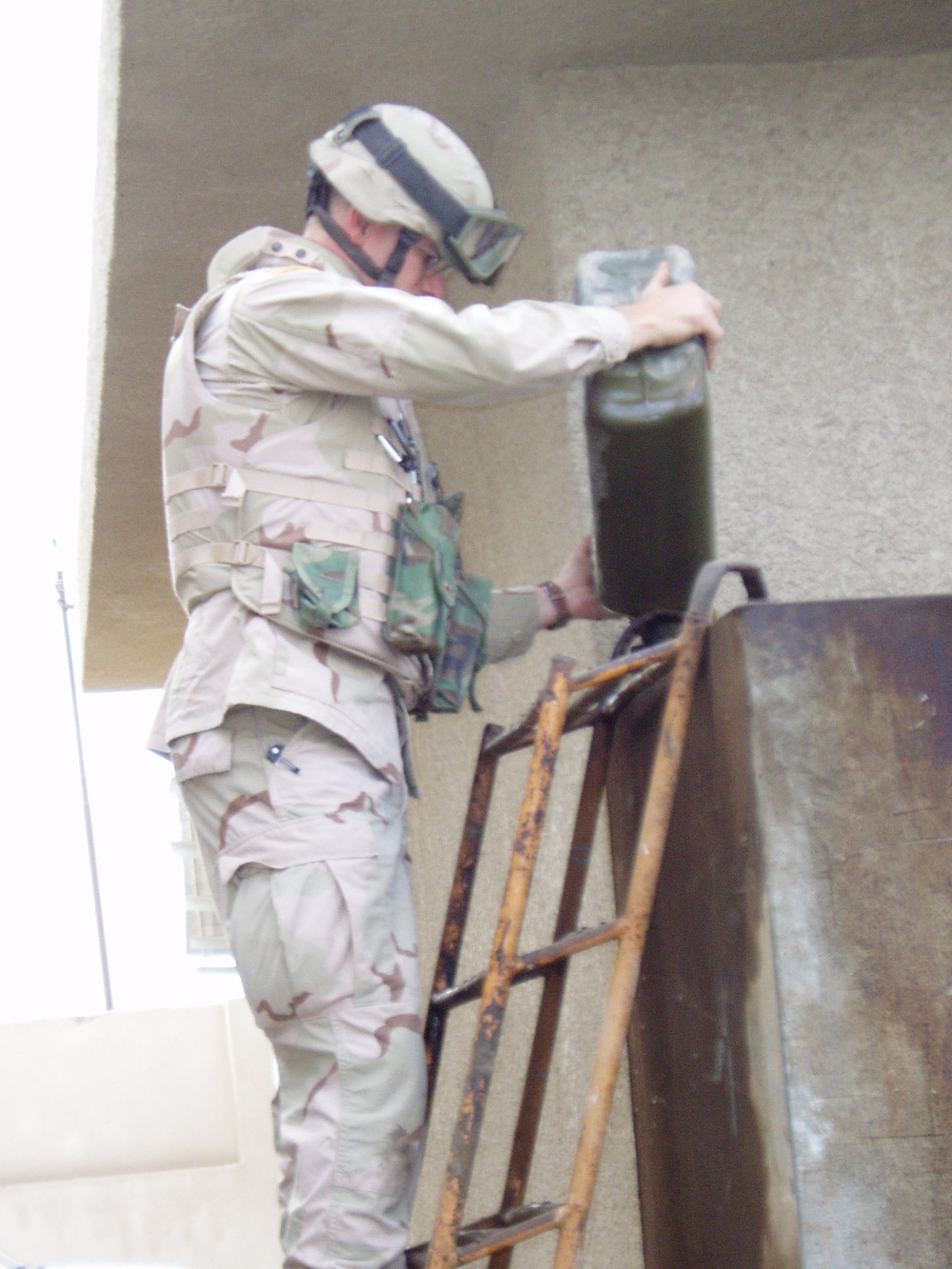 SFC Jeffery Demet pours gasoline into a generator