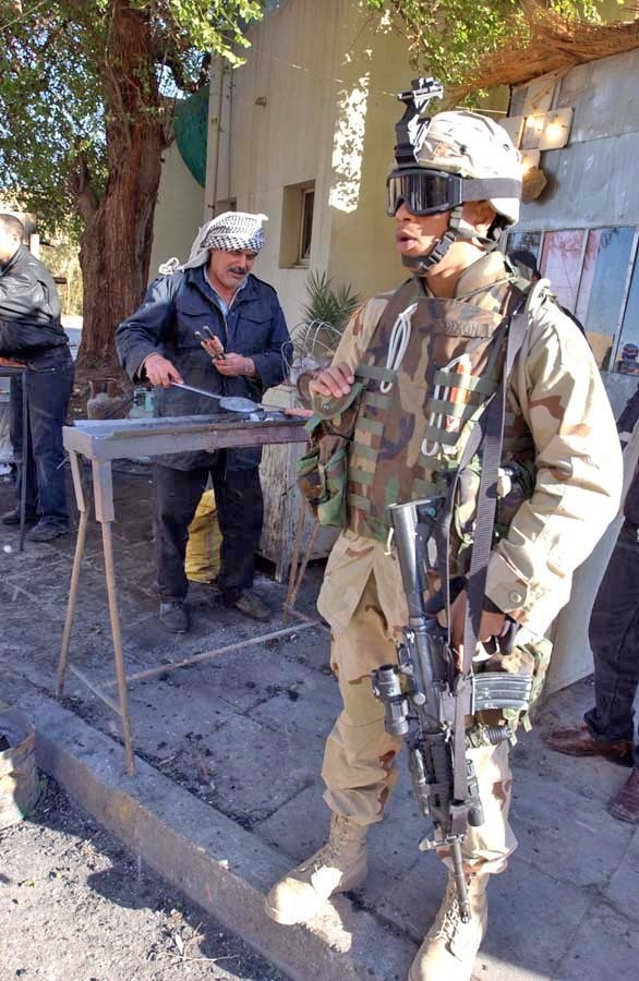 Pvt. Dixon waits for a vendor to prepare kabob