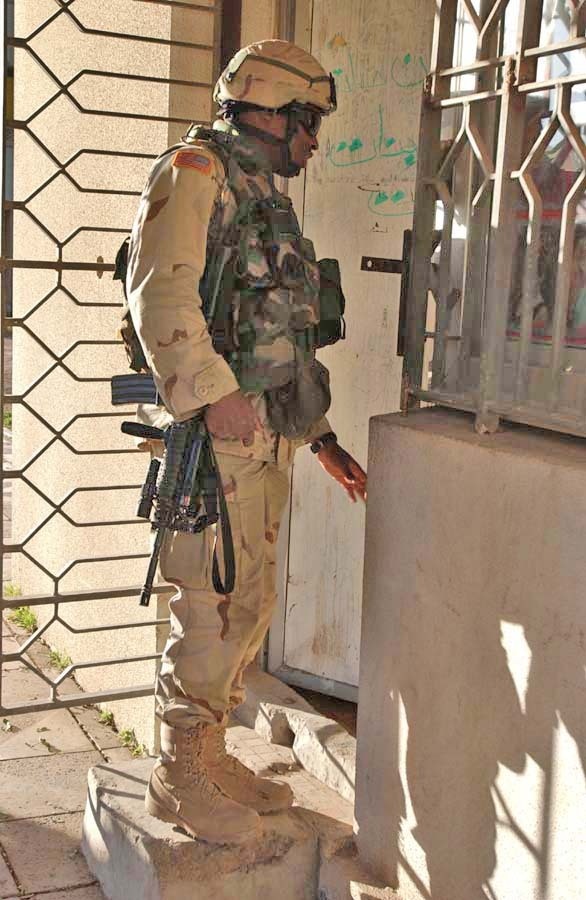 Sgt. Tawan Marks knocks on the door at a shop