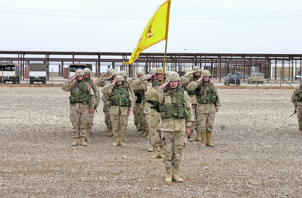 Soldiers salute during the national anthem