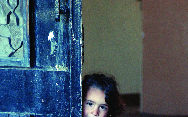 A shy little Iraqi girl peeks out