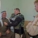 Maj. David Freel examines an Iraqi man