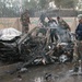 Iraqi Soldiers gather around a car that was destroyed