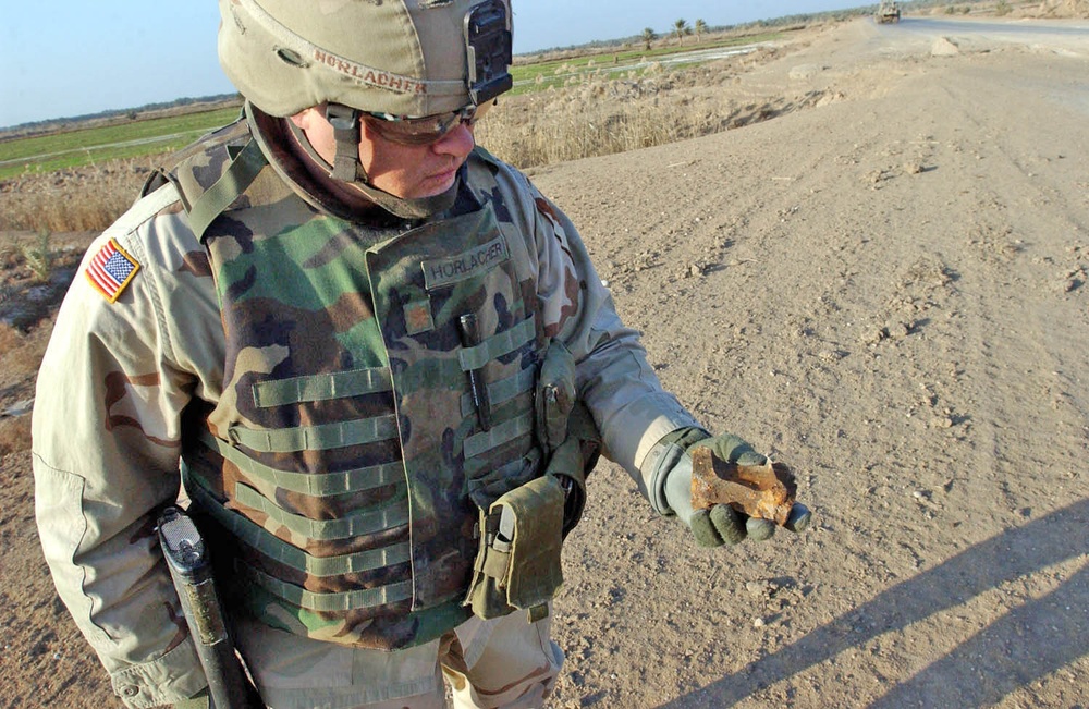 Maj. Paul Horlacher inspects a piece of shrapnel found