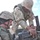 Spc. Nicholas Ketchum helps Spc. Carl Ford