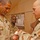 Senior Airman Weiss finishes bandaging Maj. Peter Galindez