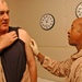 Maj. Lundy checks Lt. Col. Robin smallpox vaccination