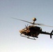 An OH58 Kiowa Warrior scout helicopter flys over