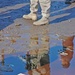 The reflection of a Soldier ripples in a puddle of kerosene