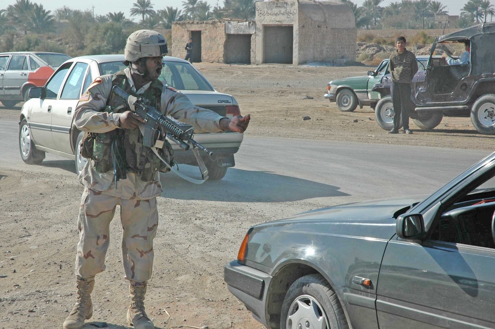 Sgt. Kim Brasfield elevates his weapon to a ready position