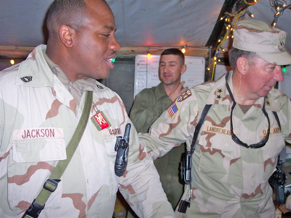 Master Sgt. Bruce Jackson is persuaded to try some snacks