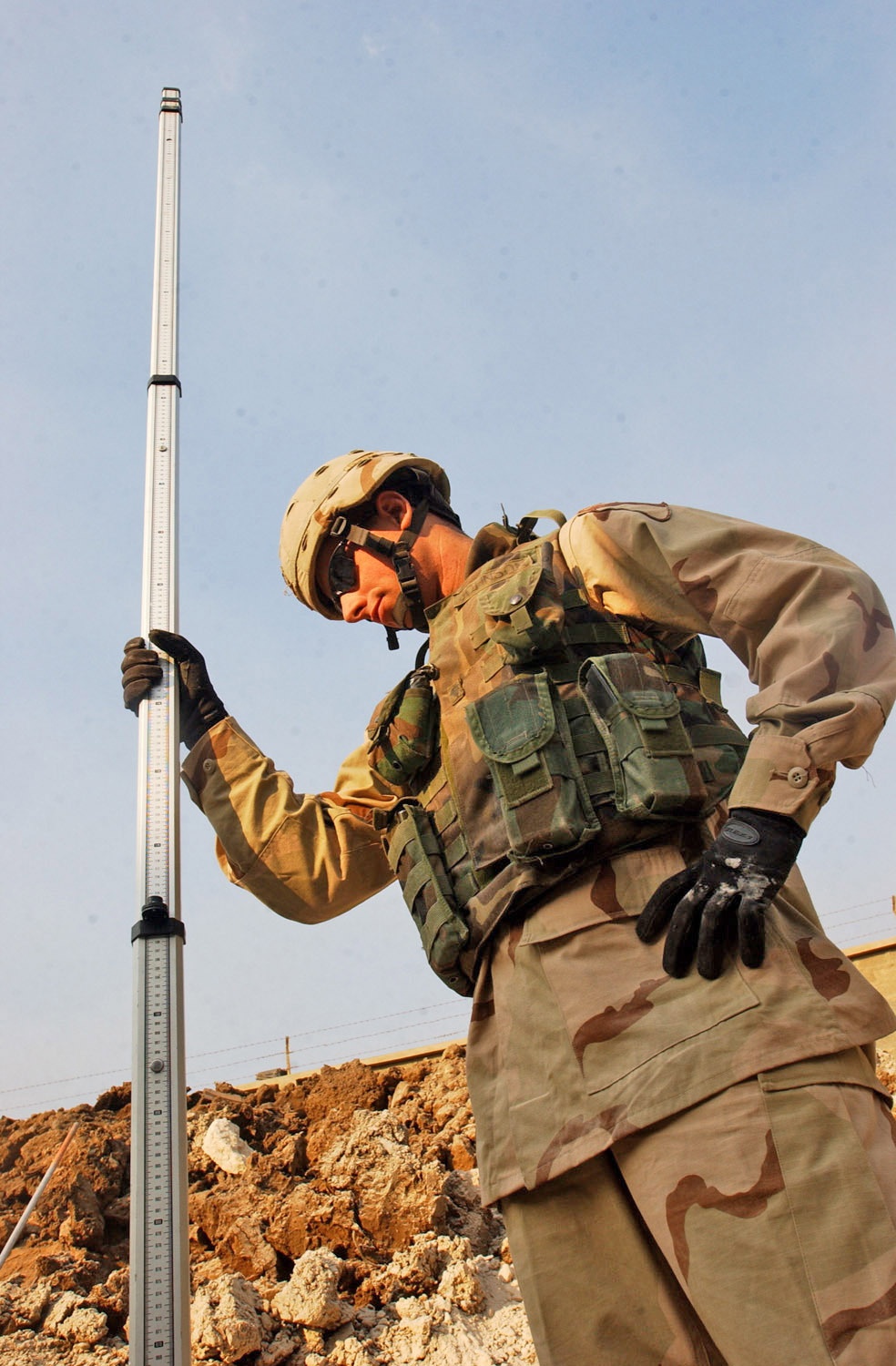Spc. Johnson holds still while elevation measurements are taken