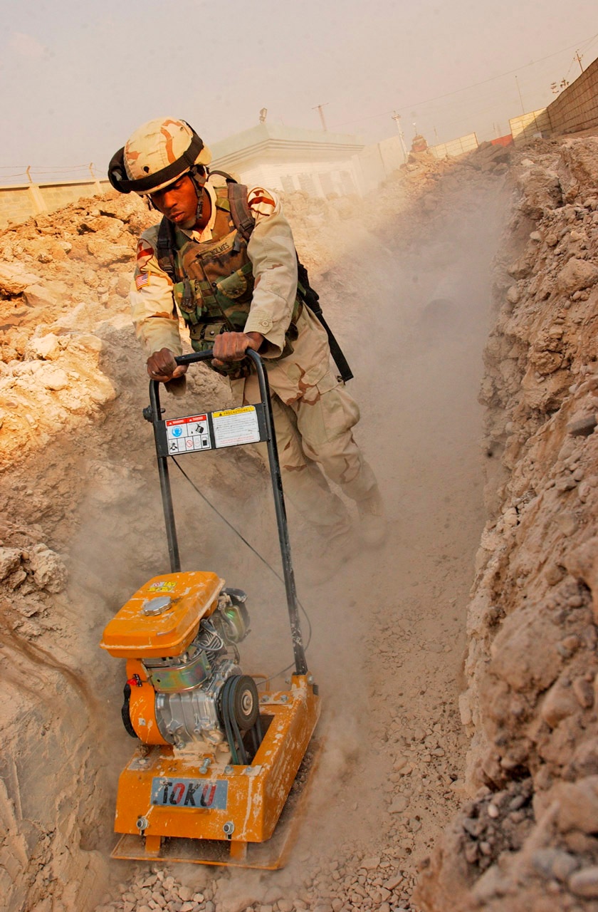Spc. Antwon Holmes uses a soil tamper