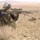 Spc. Jonathan Low scan the horizon from a hilltop