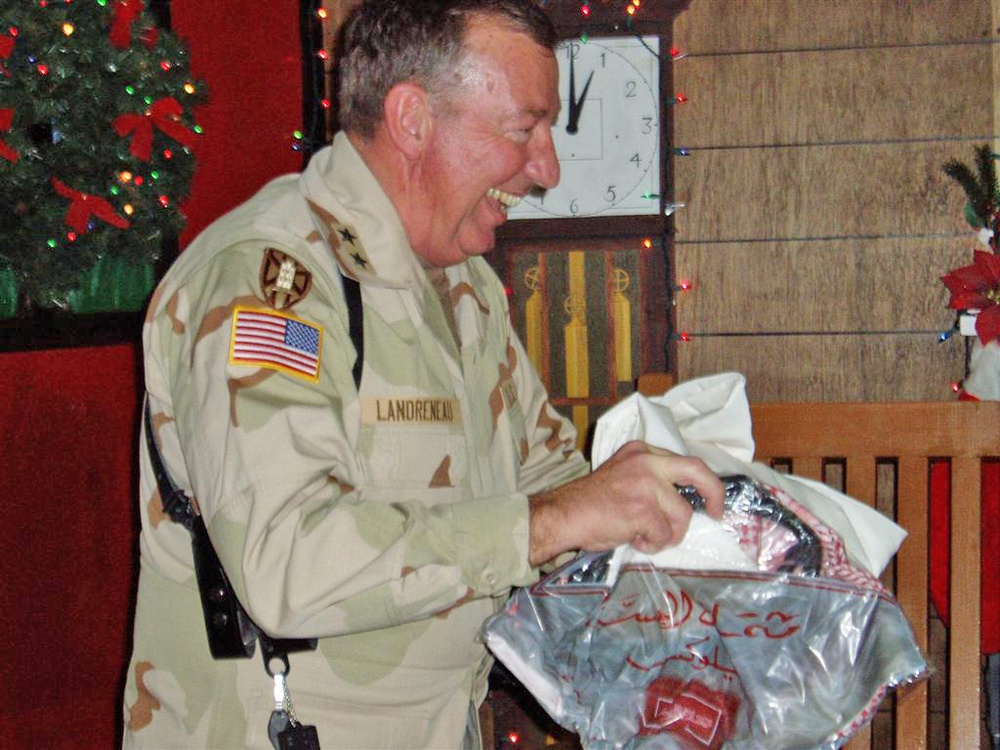 Maj. Gen. Bennett Landreneau unwraps a gift
