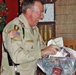 Maj. Gen. Bennett Landreneau unwraps a gift