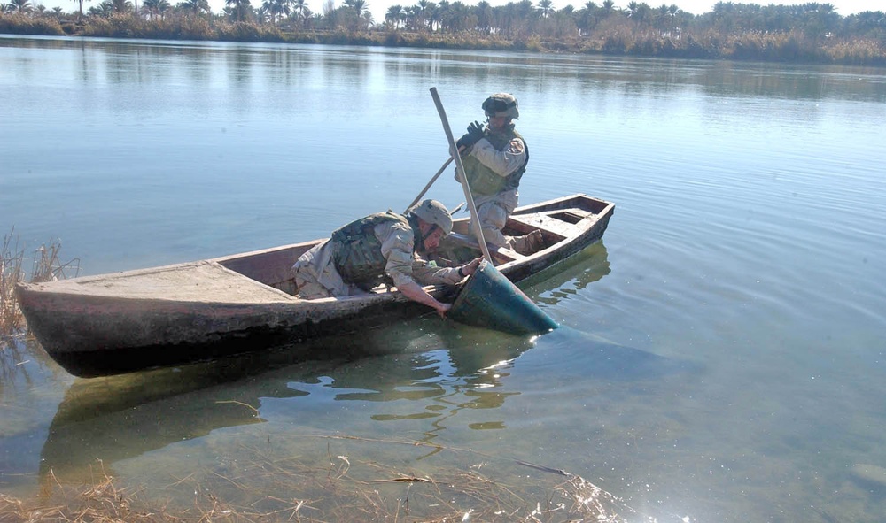 Sgt. Todd Blevins inspects a piece of suspected ordnance