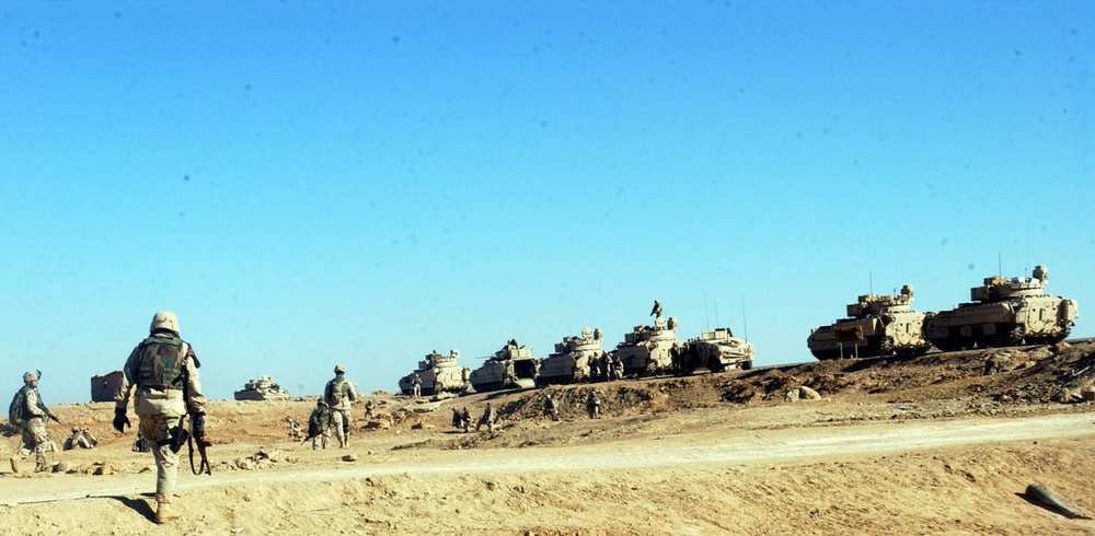 Soldiers march through palm groves