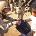 Capt. Willett hands out a backpack full of school supplies