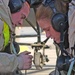 Soldiers work quickly to replace a generator control unit