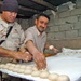 Sgt. Nolan Heanu helps make Kurdish wheat bread