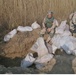 Soldiers look through bags of explosive material