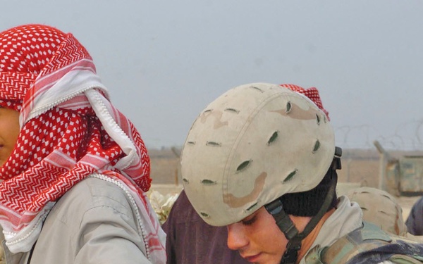 Spc. Chris Rees searches a local national employee