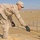 Spc. David Baker uses a tape measure to check the dimensions
