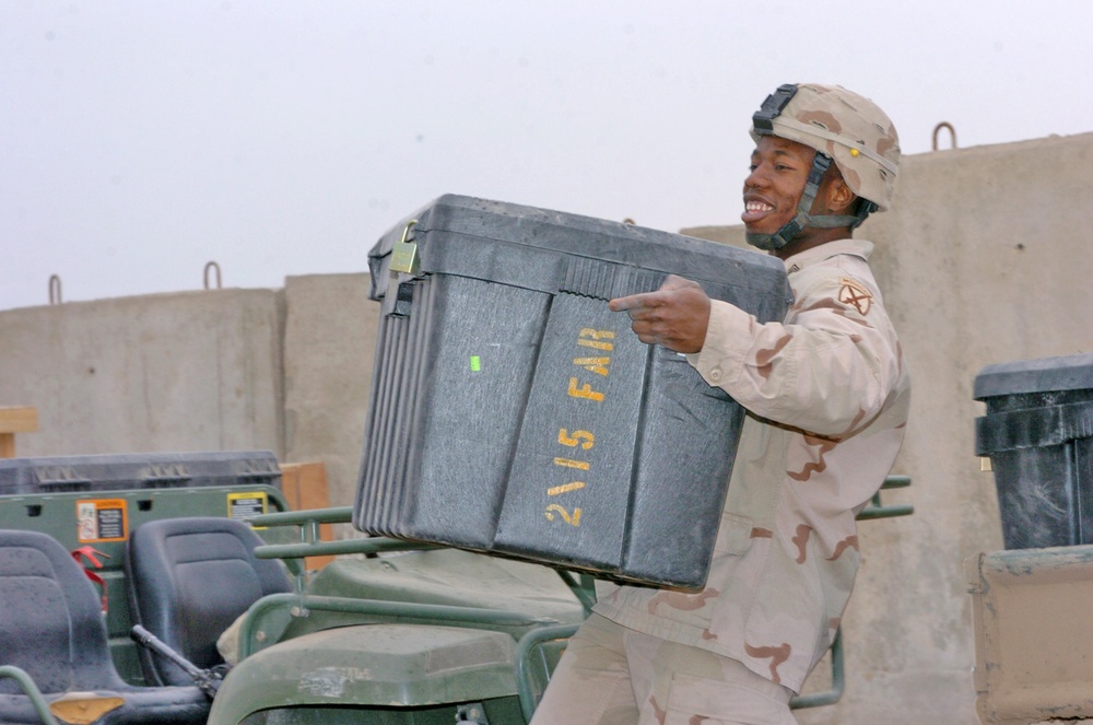 SSgt. Darrell Gray moves a  box of office supplies