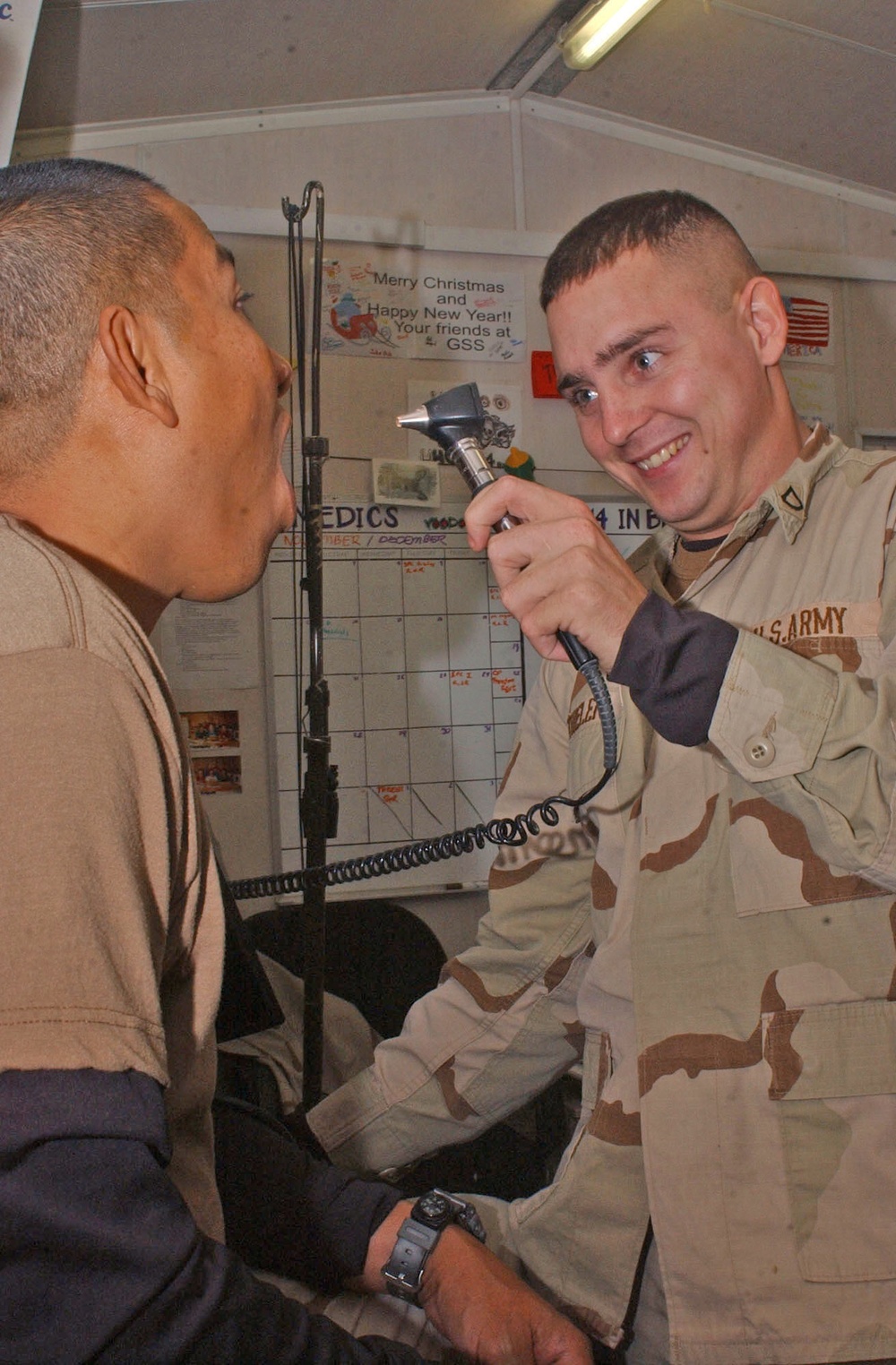 Pfc. Joshua M. Thielen checks a fellow 2-14 Inf. Soldiers throat