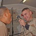 Pfc. Joshua M. Thielen checks a fellow 2-14 Inf. Soldiers throat
