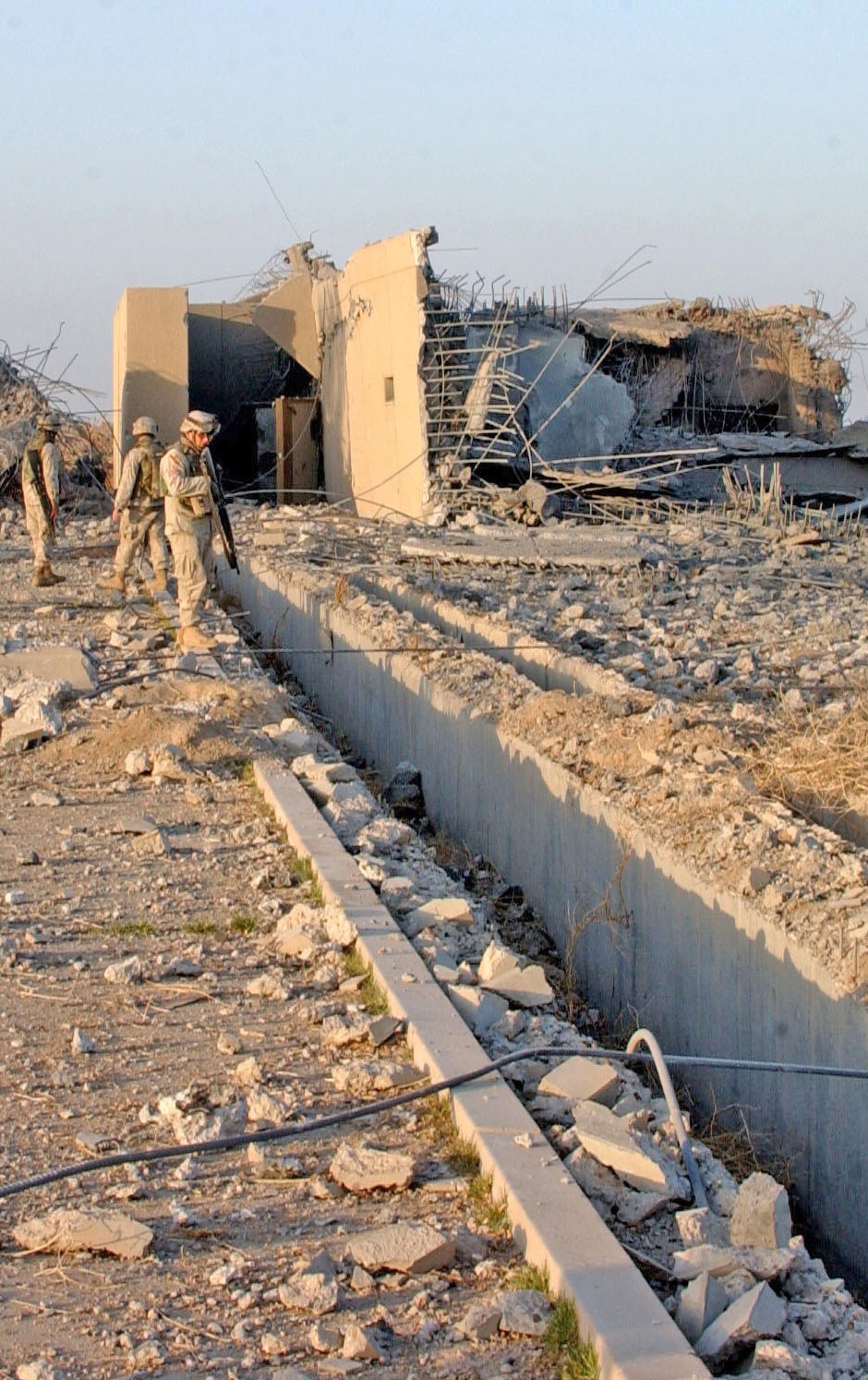 Task Force Baghdad Soldiers look through the rubble