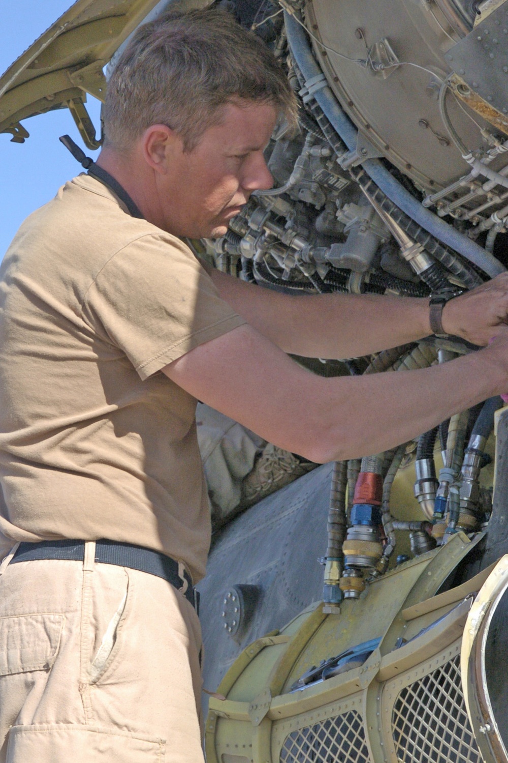 Sgt. David Wood replaces an engine in one of 14 Chinook