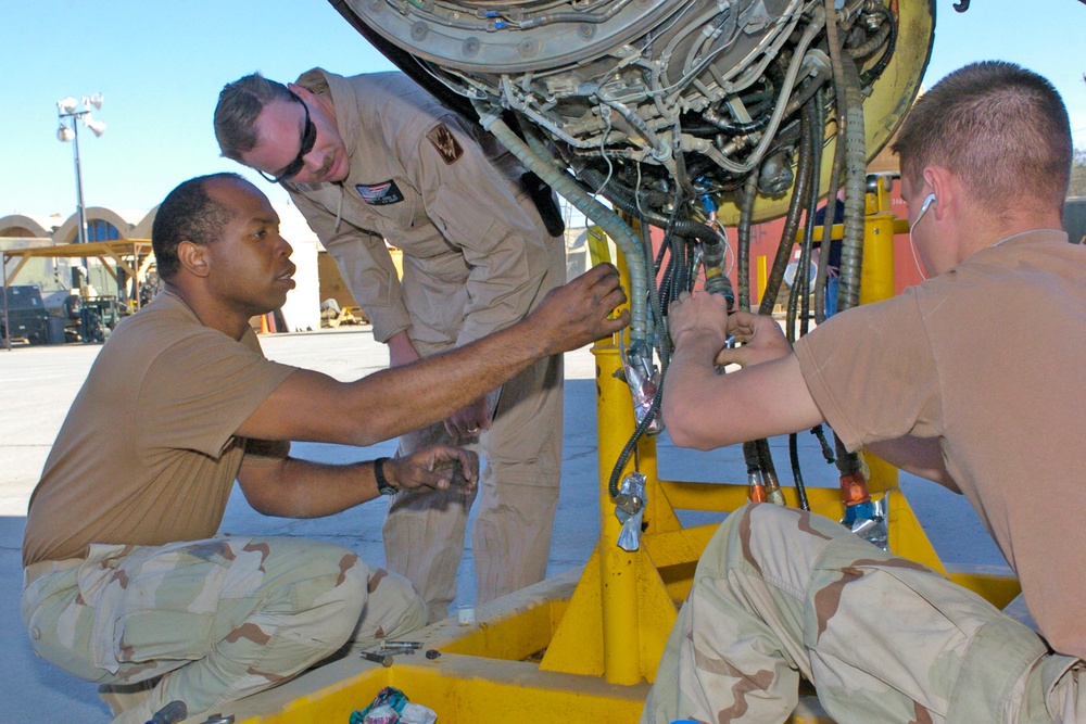 Soldiers repair a starter for one of 14 Chinooks