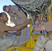 Soldiers repair a starter for one of 14 Chinooks