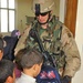 1st Sgt. Timothy Guden hands out book bags