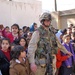 Pfc. Timothy Hall is surrounded by children