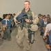 2nd Lt. Derek Reeves hands out book bags