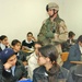 Sgt. Lanny Stottmeister helps distribute book bags
