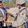 Sgt. Crochet gives a teddy bear to a local young man