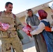 Col. Hussein Musin Bahar Al-Freejy, distributes frozen chicken