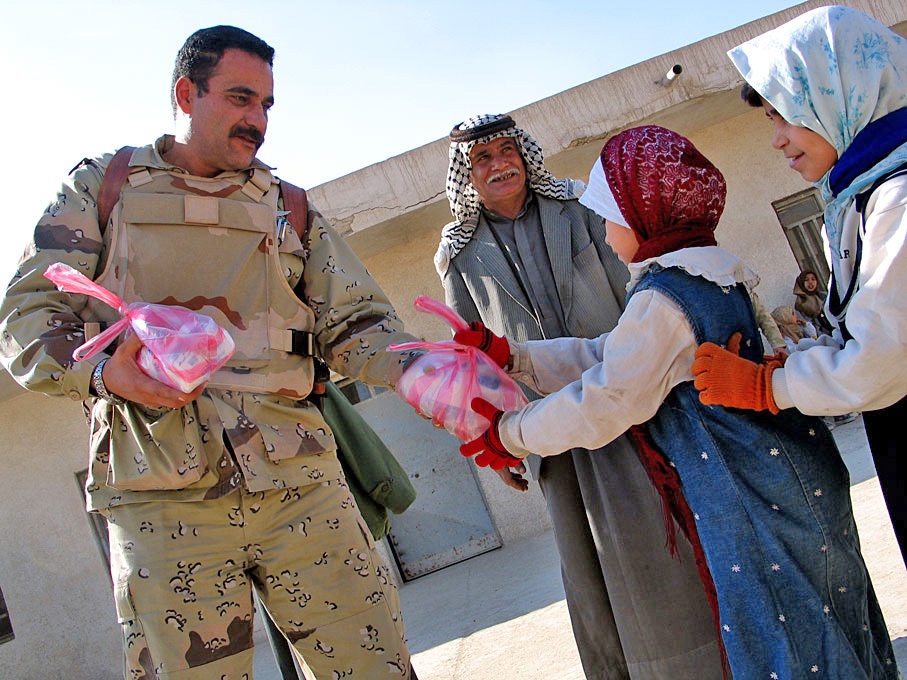 Col. Hussein Musin Bahar Al-Freejy, distributes frozen chicken