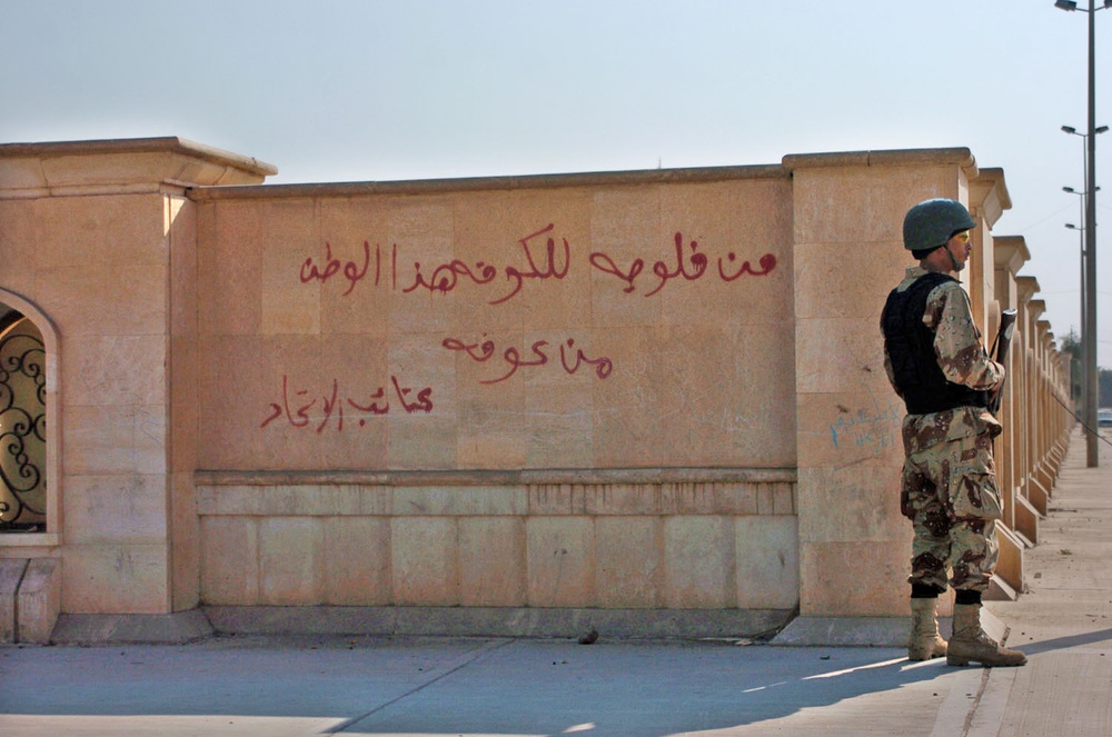 A soldier stands guard outside a polling center
