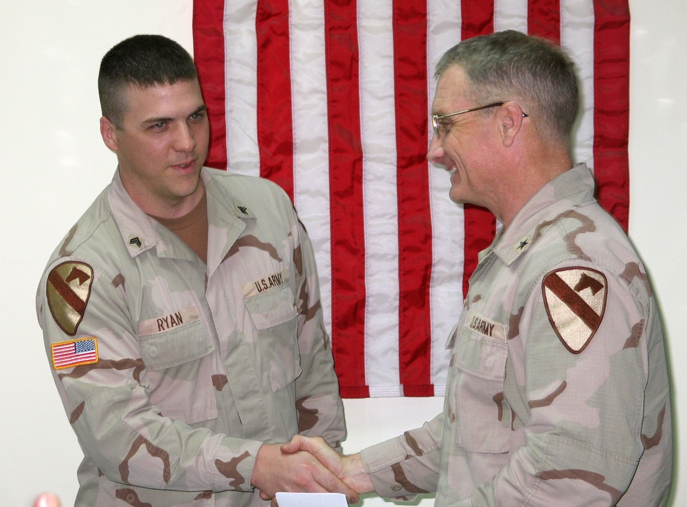 Sgt. Larry Ryan shakes hands with Brig Gen. Jeffry Hammond