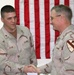Sgt. Larry Ryan shakes hands with Brig Gen. Jeffry Hammond