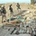 Soldiers inspect a weapons cache found during cordon