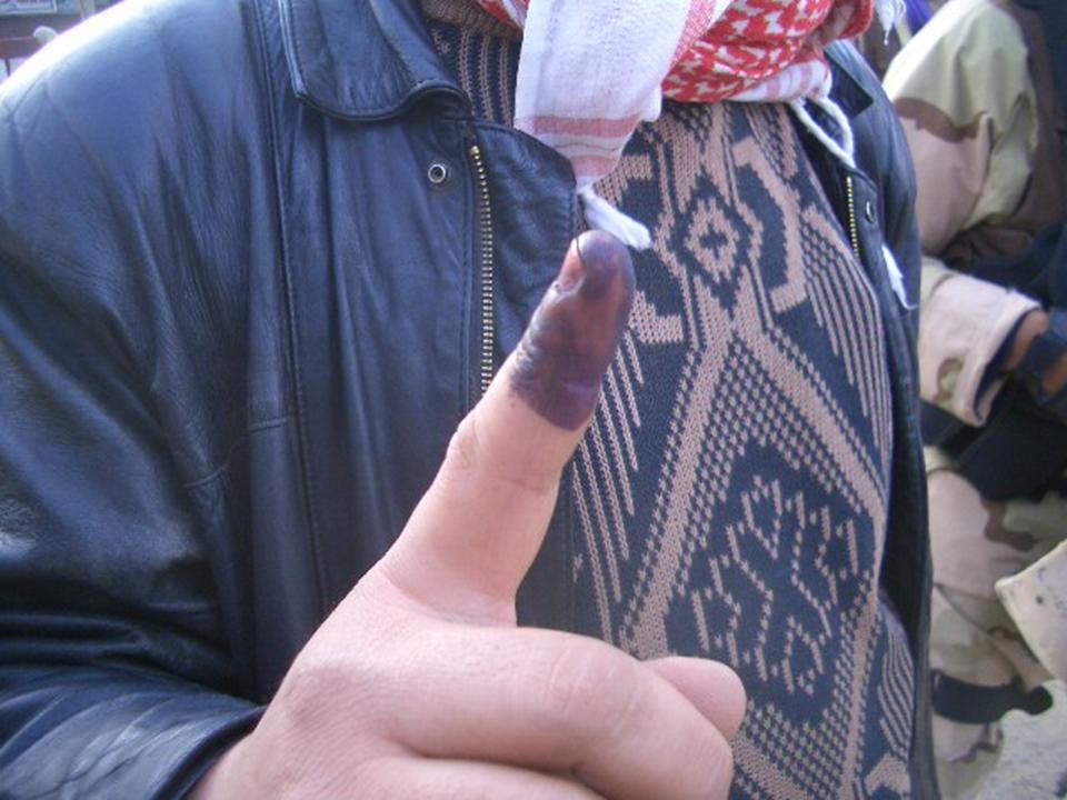 Elections: An Iraqi man proudly displays his blue finger