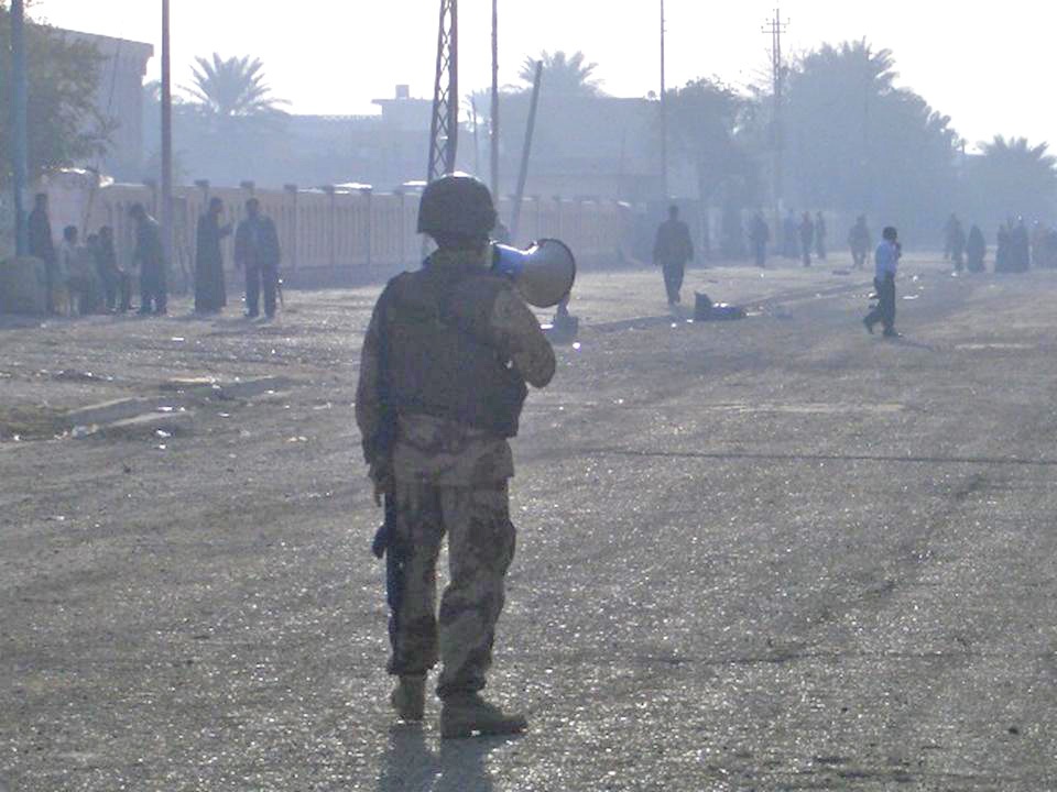 Elections: Iraqi Soldier uses a megaphone to announce instruction