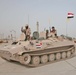 Elections: Iraqi Soldiers sit atop of their tanks