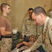 Maj. John Bride holds patient Kadaam Hassoun steady